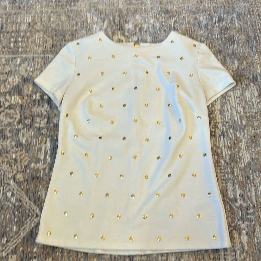 Michael Kors white top with gold accents.